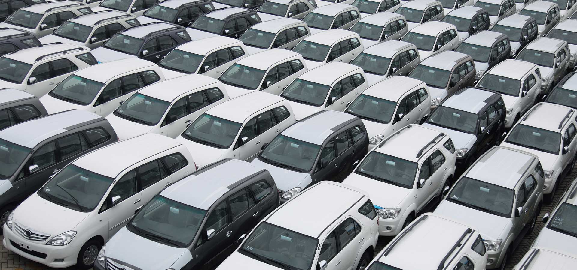 Lot full of white fleet vehicles RM auto leasing Is About Us and Your Fleet